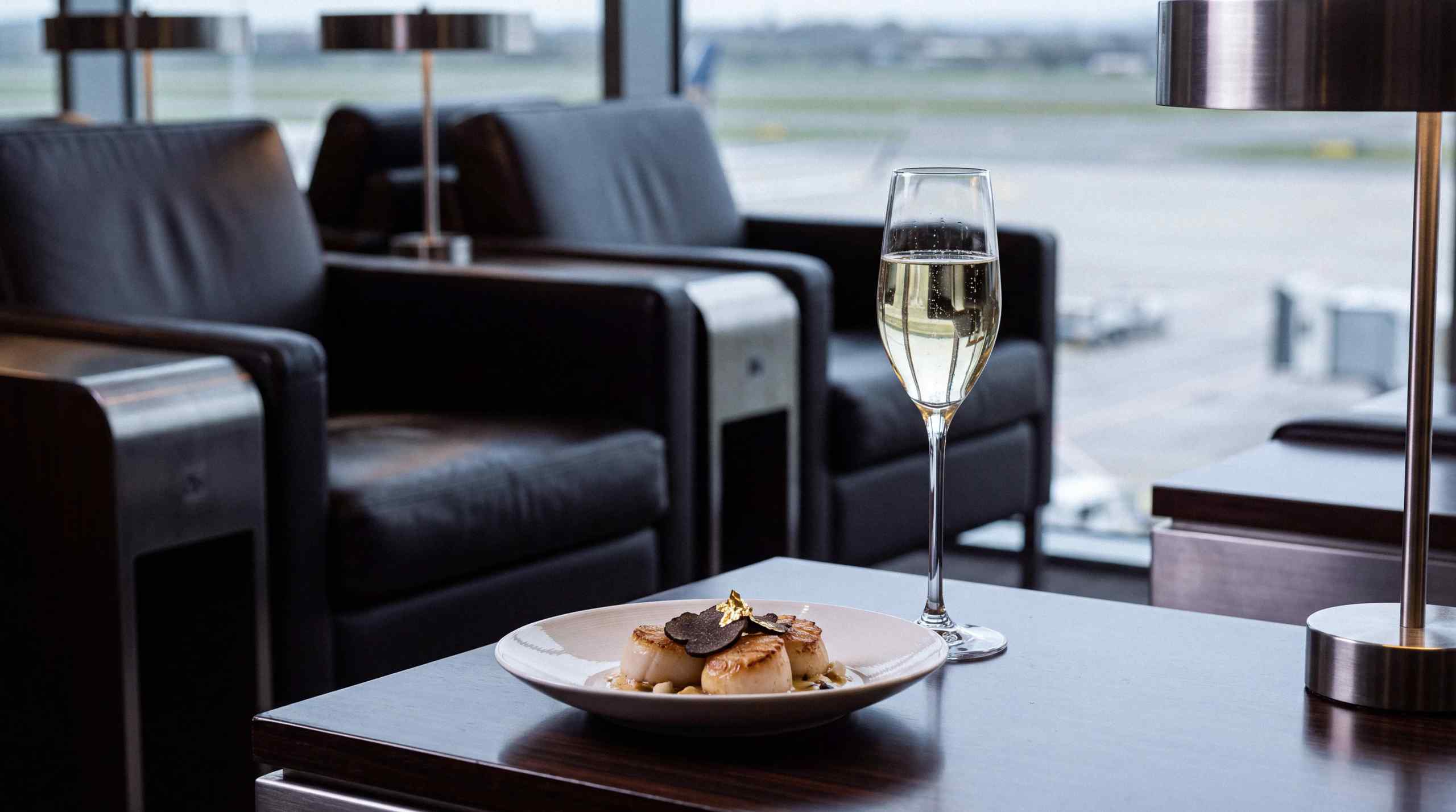 A luxury airport lounge with champaign and seared scallops.